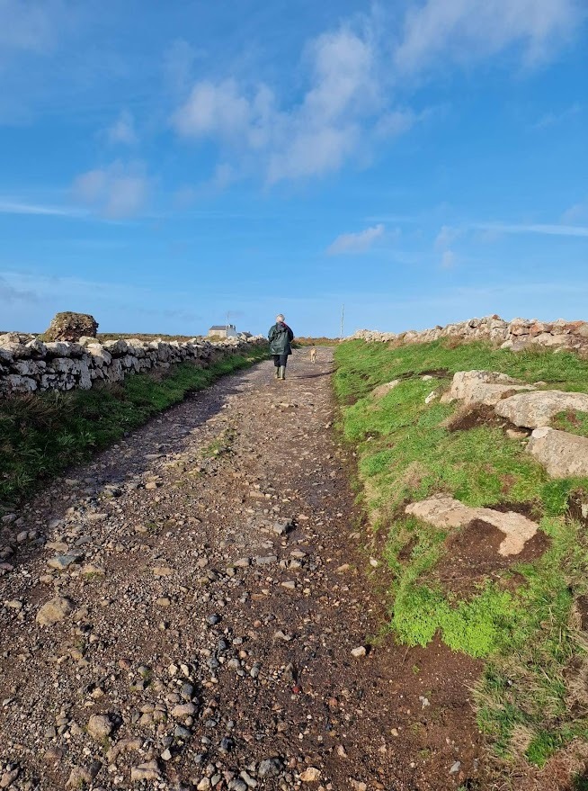 Lebanon Cottage at Botallack walking with a dog down a gravel foothpath