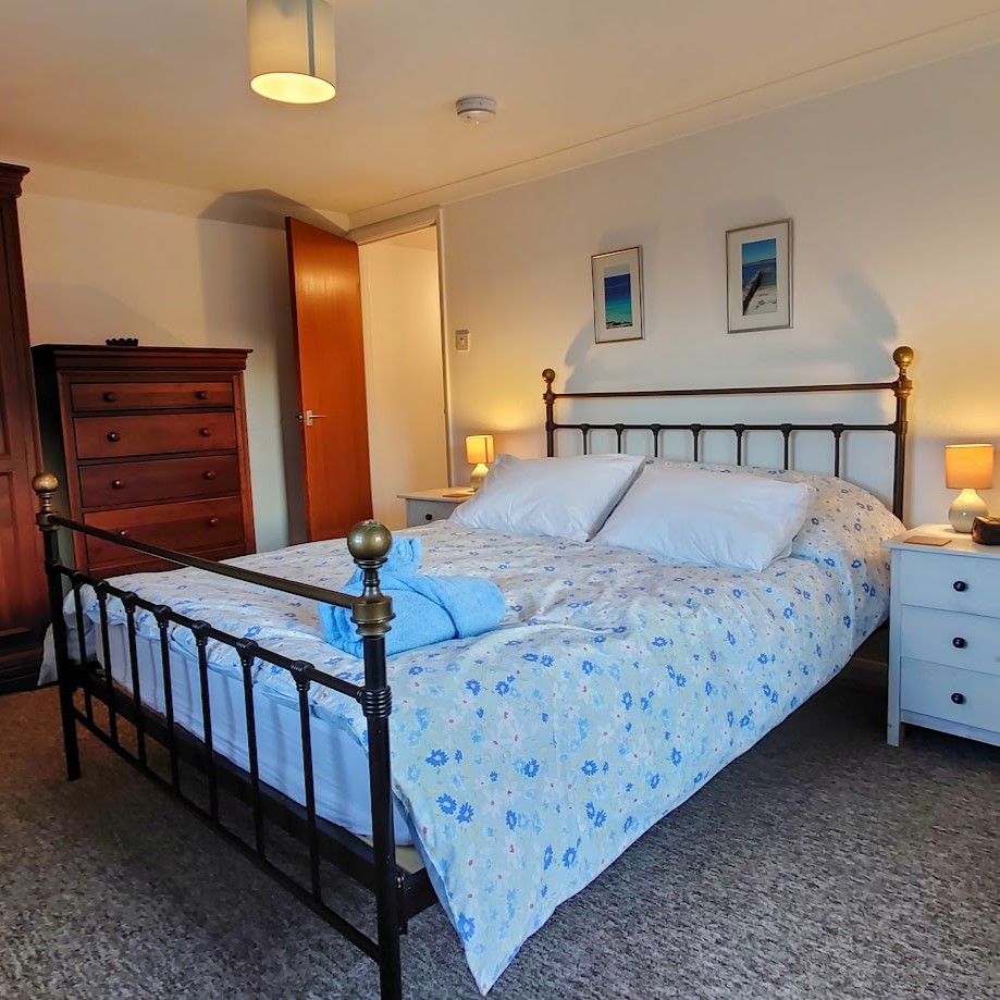 Lebanon Cottage master bedroom with king size bed, large wardrobe and chest of drawers, bed made up with crisp linen and towels laid out